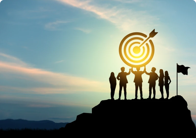 Silhouettes holding target symbol at sunset